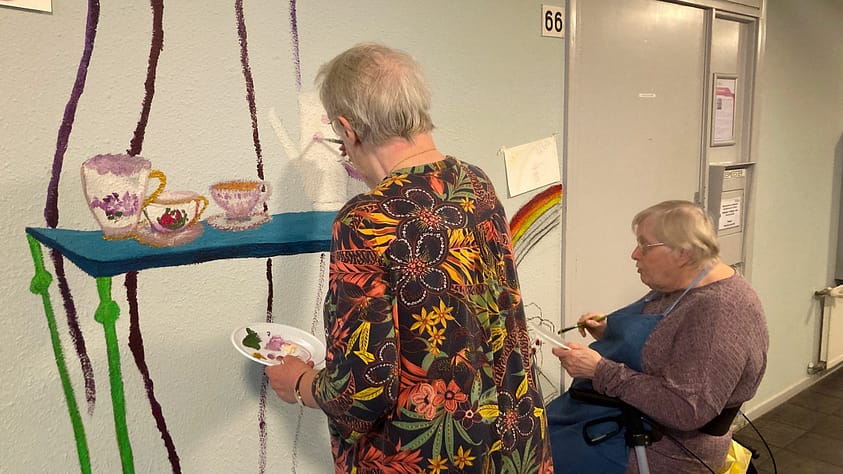 Een muurschildering van kopjes en verhalen